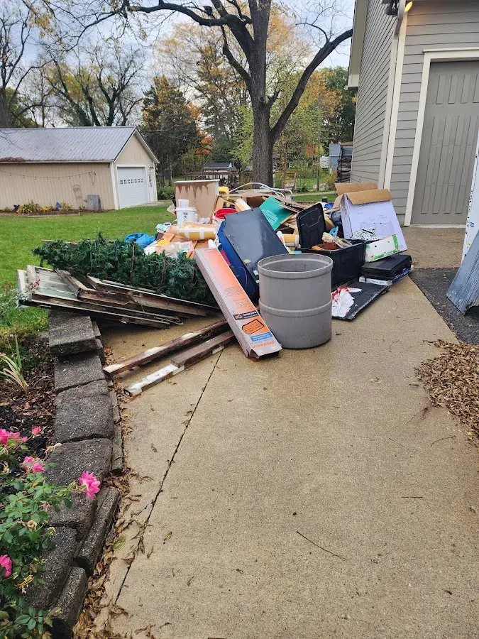 Dumpster being loaded with debris for Estate Cleanout Dumpster Rental in Sturgis